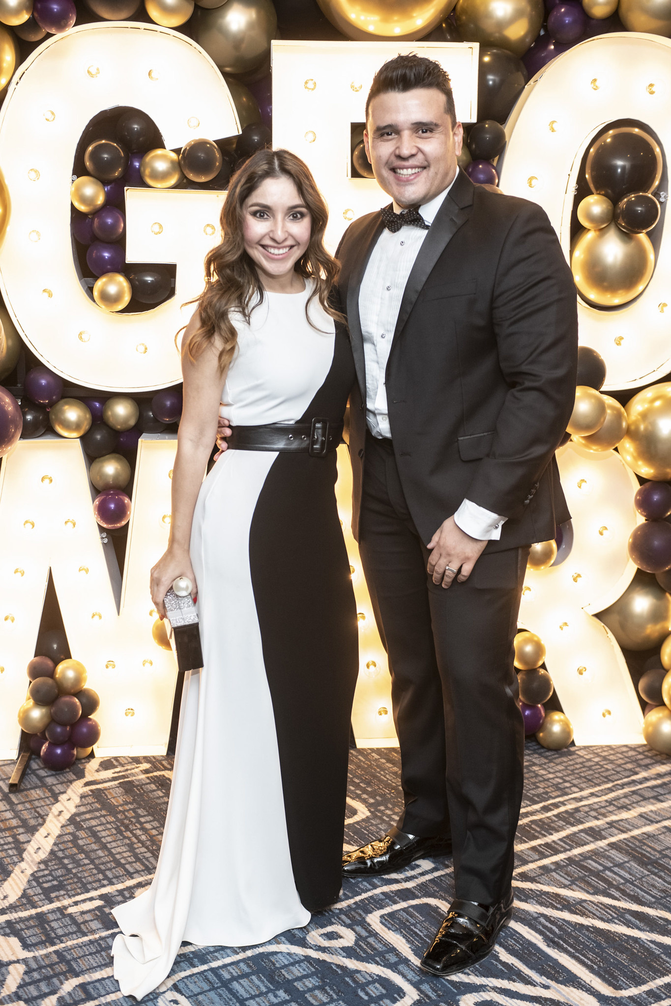 Man and woman standing with award