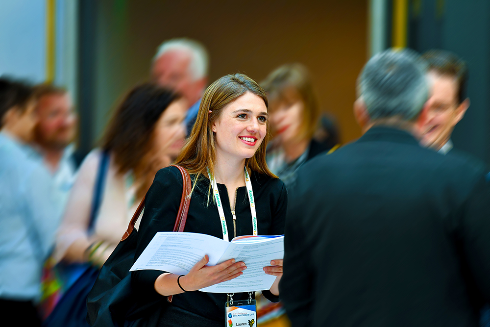 woman-holding-brochure-in-crowd