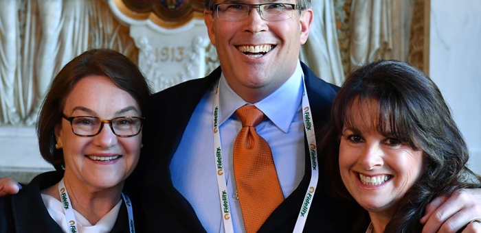 two women and one man smiling